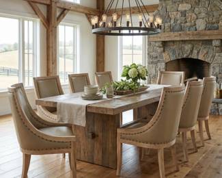 Rustic dining table with upholstered dining chairs, substantial dining room furniture and lodge-inspired entertaining decor.