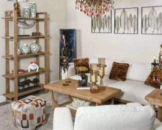 Bohemian living room furniture with a natural wood coffee table, neutral sofa, open display shelving and eclectic home accents.