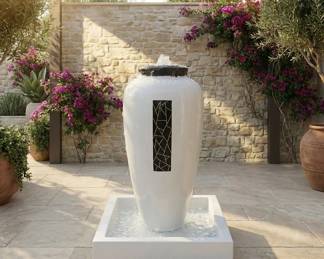 Tall white urn fountain with a square basin, contemporary garden water feature and courtyard patio decor.