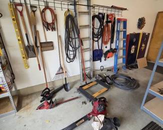Wall of Tools Garage  Lawn Care Tool Collection with Ladders, Leaf Blowers  Yard Tools