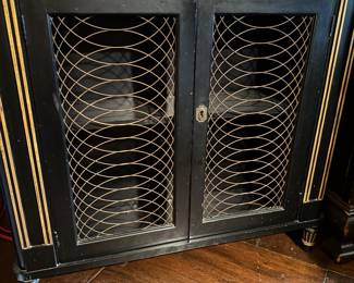 Baker Hollywood Regency shallow bar cabinet w gold trim and grills.