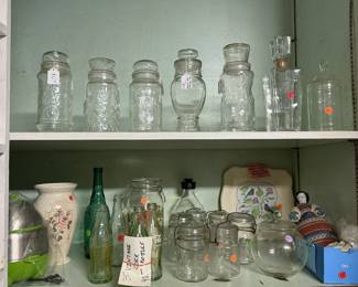 Variety of vintage glassware including several collectible Mr. Peanut jars.