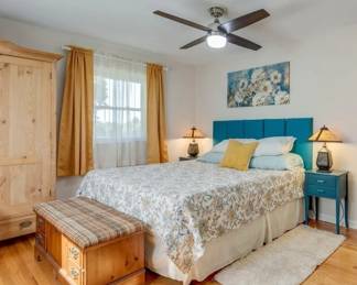 King size sleep number bed, wall mounted headboard, night stands, blanket chest, artwork, lamps
