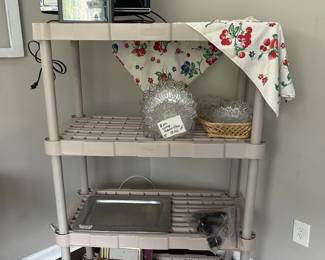 computer monitor, clock radio, Federal glass plates, and a vintage table cloth