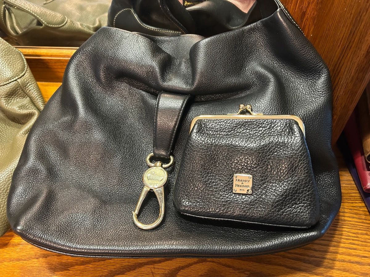 Dooney & Bourke Black Leather Hobo Bag with Coin Purse [IMG_2462] A black pebbled leather hobo-style shoulder bag with a key fob clip and a matching kiss-lock coin purse with a Dooney & Bourke plaque. A classic designer leather handbag for everyday use. The leather looks soft with light wear.