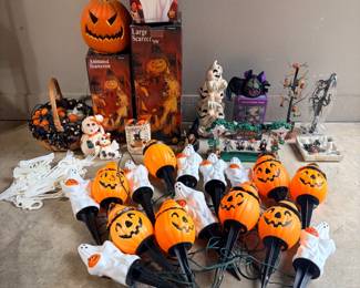 Halloween Decor Lot – Pumpkin and Ghost Pathway Lights and Animated Figures A Halloween lot with jack-o'-lantern and ghost pathway stake lights, boxed Animated Scarecrow and Shrieking Ghost figures, a skull, ghost figurines, a Halloween tree and a village scene. Lighting and animation not confirmed — sold as found.