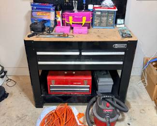 Kobalt Workbench with Pegboard, Craftsman Toolbox, Shop Vac and Extension Cords A Kobalt workbench with a pegboard back and light, drawers and a lower shelf, along with a red Craftsman toolbox, a gray toolbox, a red and black shop vacuum, orange extension cords and assorted tools and organizers. Working condition not confirmed — sold as found.