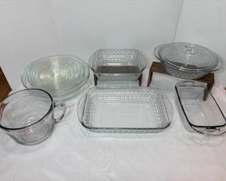 Clear Glass Bakeware Lot – Pie Plates, Baking Dishes and Batter Bowl A lot of clear glass bakeware, including stacked pie plates, rectangular baking dishes with textured sides, a lidded casserole, a loaf pan and a large handled batter bowl. Everyday glass bakeware for the kitchen.