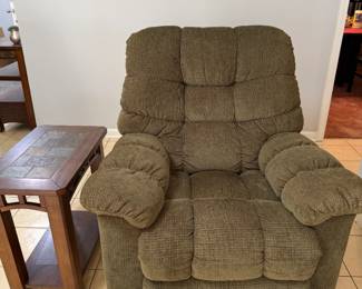 Green Overstuffed Recliner with Slate Tile End Table An olive green overstuffed recliner with pillow arms and a tufted back, shown with a wood end table with a slate-look tile top and lower shelf. A comfortable reading or TV chair for a den or living room. Recliner function not confirmed — sold as found.