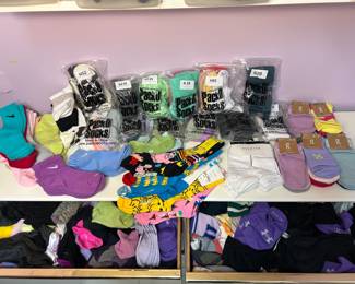 Socks Lot – PackO Socks, On, Nike, Under Armour and More A large lot of socks, including packaged PackO Socks, On socks with tags, Nike and Under Armour socks, and novelty print socks, plus two drawers of additional pairs. A bulk sock lot for athletes and families.
