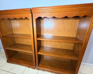 Pair of Oak-Finish Bookcases with Scalloped Trim Two oak-finish bookcases with scalloped top aprons, molded tops and three open shelves each. Traditional open bookshelves for a library, office or family room. The finish looks warm and even in the photo.