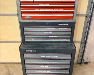 Craftsman Tool Chest and Rolling Cabinet A Craftsman stacking tool storage system with a red multi-drawer top chest with an Edelbrock badge and two gray Craftsman rolling cabinets with labeled drawers. Heavy-duty garage tool storage for a mechanic or DIYer. The finish shows normal shop wear.