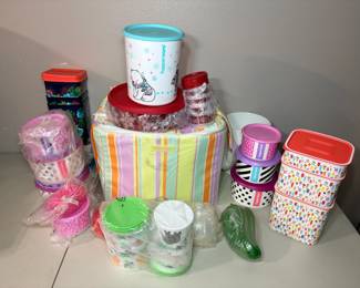 Tupperware Lot – Canisters, Containers and Insulated Bag A Tupperware lot with printed canisters, stacking containers, a polar bear canister, snack cups, a green pickle-shaped container and a striped insulated bag. Many pieces are still in plastic wrap. A fun lot for Tupperware collectors.