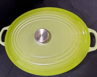 Le Creuset Green Oval Dutch Oven A Le Creuset oval Dutch oven in bright green enamel, shown from above with the Le Creuset stainless knob and embossed lid. Enameled cookware for braising and slow cooking. The lid enamel looks bright and even in the photo.