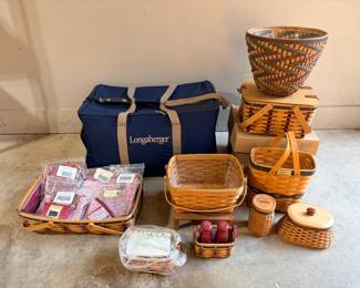 Longaberger Baskets with Longaberger Carry Bag and Accessories A lot with a navy Longaberger carry bag, assorted woven baskets with lids, a large woven waste basket, salt and pepper shakers in a small basket, packaged fabric liners and boxed accessories. A great lot for basket collectors and home storage.