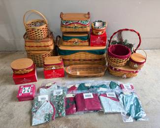 Longaberger Tree Trimming Christmas Baskets with Liners A lot of Christmas-themed woven baskets with red and green trim, including lidded baskets, baskets in red Longaberger Tree Trimming boxes, and many packaged holiday fabric liners. A festive basket collection for holiday decorating or gifting.