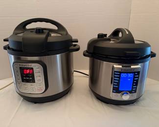 Instant Pot Electric Multi-Cookers – Pair Two Instant Pot electric multi-cookers with stainless exteriors: one with a red LED display and button panel, and one with a blue LCD screen and dial control. Countertop pressure cookers for quick weeknight meals. Working condition not confirmed — sold as found.