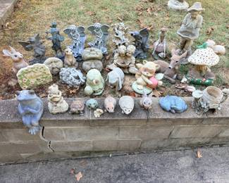 Garden Statuary Lot – Fairies, Animals, Frogs and More A large lot of garden statues, including fairies, angels, rabbits, turtles, frogs, a deer, a raccoon, a mushroom, moon faces, a welcome sign and a fisherman figure. A whimsical lot for fairy gardens and flower beds. Weathering consistent with outdoor use.