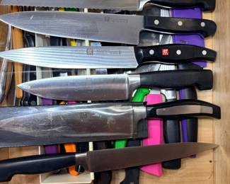 Kitchen Knife Drawer Lot with Zwilling Knives A drawer of kitchen knives, including Zwilling-marked bread, chef's and carving knives, plus colorful paring and utility knives with sheaths and other cutlery. A practical knife lot for a home cook. Check edge condition in person.