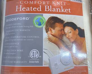 Biddeford Comfort Knit Twin Heated Blanket in Package A Biddeford Comfort Knit heated blanket in twin size, in its packaging, which lists ten heat settings and an analog controller with auto-off. A cozy electric blanket for winter. Working condition not confirmed — sold as found.