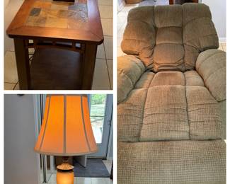 Slate Tile End Table, Table Lamp and Green Recliner A living room grouping with a wood end table with a slate-look tile top and lower shelf, a table lamp with an amber glass body and pleated shade, and a green overstuffed recliner. Recliner function not confirmed — sold as found.