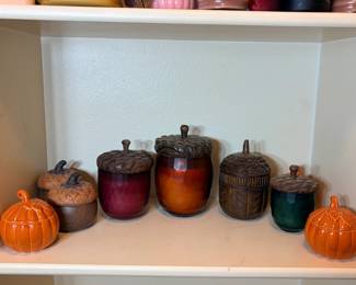 Acorn Lidded Candle Jars and Pumpkin Jars A fall decor lot with acorn-topped candle jars in red, amber, brown and green glass, carved-look acorn lidded containers and two orange pumpkin jars. An easy, warm autumn tablescape.