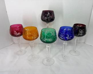 Cut-to-Clear Colored Wine Glasses – Set of Seven Seven cut-to-clear colored wine hocks in amethyst, cranberry, amber, green, cobalt and ruby, with grape, leaf and geometric cut designs on cut clear stems. A striking set to display in a china cabinet or use for special occasions.