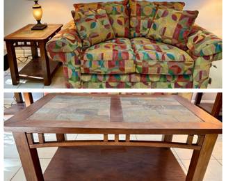 Geometric Print Loveseat with Slate Tile Coffee Table and End Table A loveseat in a bold multicolor geometric fabric with matching throw pillows, plus a coffee table and end table with slate-look tile tops, lower shelves and Craftsman-style slat details. A cheerful living room set. The upholstery looks clean in the photo.