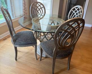 Round 48" glass-top dining table with a decorative pedestal base & 4 upholstered chairs $400