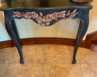 Dark painted distress concept table featuring metallic Rose trim along with the serpentine apron and slender Cabriole legs