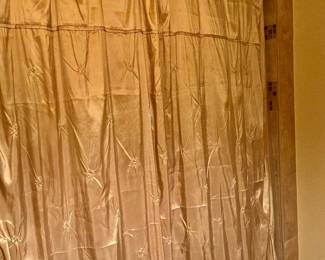 Golden, beige shower curtains with shower curtain rings
