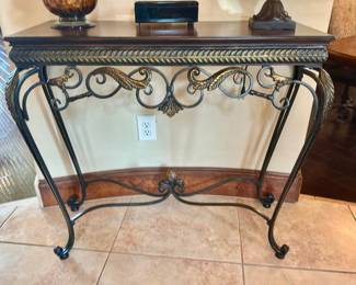 Console style table with metal iron base and dark wood top