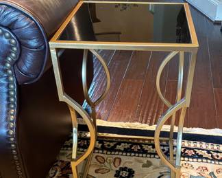 Modern glam square accent side table with gold, finish metal frame, and insert black glass top