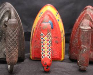 3 Antique Cast Iron Sad/Flat Irons Featuring Patterned Handles And Colorful Finishes