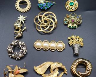 Assortment Of Vintage Gold-Tone Fashion Brooches Featuring Various Designs