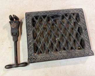Cast iron pipe wrench & air duct register.