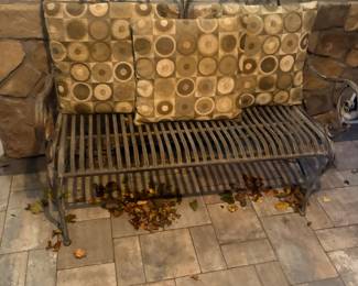 Metal ornate bench with pillows