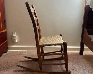 H18 - $30. Shaker Style Ladderback Rocking Chair. Measures 16.5" x 17" x 32"T, floor to seat 15.75"T. Some surface wear, but structurally sound.