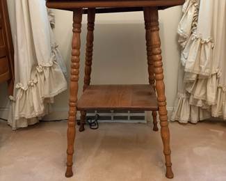 H25 - $50. Parlor Table with Bobbin Turned Spindle Legs. Measures 19.5" x 19.75" x 28.75"T. Trim piece is starting to separate from tabletop as shown in photo.