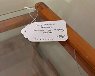 H50 - $450. Tom's toasted peanuts countertop display cabinet. Measures 24" x 12" x 16" tall. One top corner has cracked glass but it's still in the case.