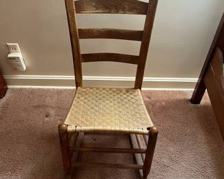H18 - $30. Shaker Style Ladderback Rocking Chair. Measures 16.5" x 17" x 32"T, floor to seat 15.75"T. Some surface wear, but structurally sound.