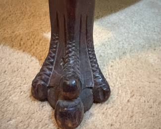 H31 - $75. Adjustable height carved piano stool. Measures 14.5" x 19"T.