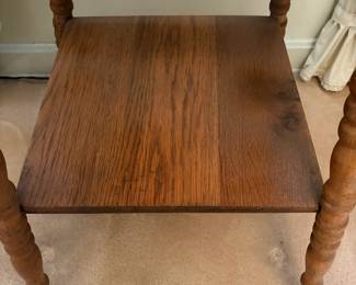 H25 - $50. Parlor Table with Bobbin Turned Spindle Legs. Measures 19.5" x 19.75" x 28.75"T. Trim piece is starting to separate from tabletop as shown in photo.