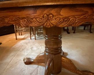 H42 - $150. Clawfoot pedestal dining table with 6 chairs and leaf. Table measures 48" x 30"T, Chairs measure 17.75" x 16" x 43"T, floor to seat 18"T. Two chairs have splitting in the seat as shown in photo.