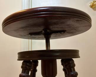 H31 - $75. Adjustable height carved piano stool. Measures 14.5" x 19"T.