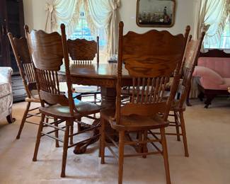H42 - $150. Clawfoot pedestal dining table with 6 chairs and leaf. Table measures 48" x 30"T, Chairs measure 17.75" x 16" x 43"T, floor to seat 18"T. Two chairs have splitting in the seat as shown in photo.