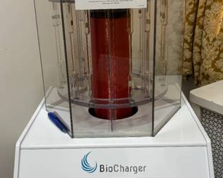 BioCharger NG subtile energy Health Optimization Platform Tesla coil technology device and matching storage cart shown The crown jewel of modern biohacking and elite cellular performance fields. world-class health optimization platform utilizing a custom Tesla coil geometry to simultaneously broadcast four distinct natural energies: Light (via noble gas glow tubes), Harmonics/Frequencies, Voltage, and Pulsed Electromagnetic Fields (PEMF). This magnificent asset features an interactive touchscreen control panel with cloud-connected recipe profiles and comes pristine upon its custom wheeled multi-tier storage console. Excellent for longevity centers, premium athletic complexes, or luxury private residences.