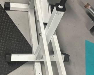 Heavy-Duty Seated Calf Raise Machine  designed for absolute lower-body isolation. Features an ultra-stable, cross-braced white steel frame with adjustable knee padding and dual Olympic plate storage pegs. This specialized, heavy-gauge steel asset delivers a smooth, bio-mechanically precise pivot point perfect for a high-tier personal training studio or dedicated home gym.