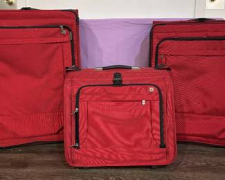 The Red Executive 3-Piece Rolling Luggage Suite Travel with effortless visibility. This elegant, matching three-piece executive rolling luggage suite features an identical rich crimson structural fabric weave that stands out beautifully at any terminal carousel. The collection includes a grand large-format packing case for extended voyages, a versatile rolling multi-pocket intermediate case, and a compact rolling vertical cabin bag perfectly scaled for quick overhead storage. Outfitted with heavy-duty reinforced zippers, telescopic ergonomic handles, and durable corner wheel builds, this matching set is ready to handle years of sophisticated adventures.