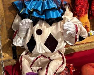 The "Carnival Terror" Lifesize Animated Clown Prop Covers the articulated, standing clown prop with red hair and a diamond-patterned satin jumpsuit. A premier visual anchor for a high-end circus, carnival, or horror display. This life-sized, articulated menacing clown feature stands out with striking, vibrant crimson hair and detailed theatrical facial sculpting. Outfitted in a pristine, custom-tailored diamond-patterned satin jumpsuit with a brilliant layered blue-and-black ruffle neck collar and matching white gloves, this premium character asset is engineered to deliver immediate psychological dread.